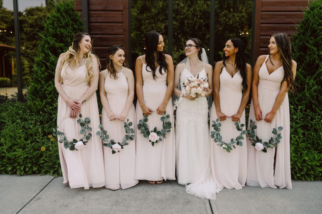 bride and bridesmaids wearing pink dresses at The Heartland Lodge