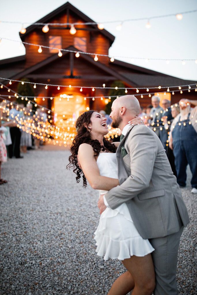 couple kissing at wedding departure at The Heartland Lodge